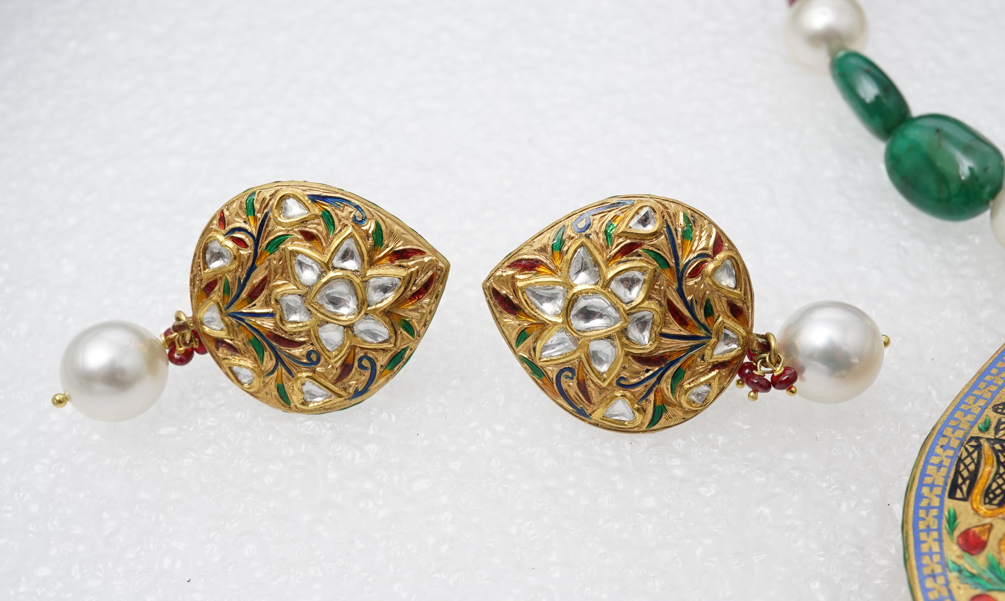 An emerald, ruby, enamel, cultured pearl and diamond demi-parure, India